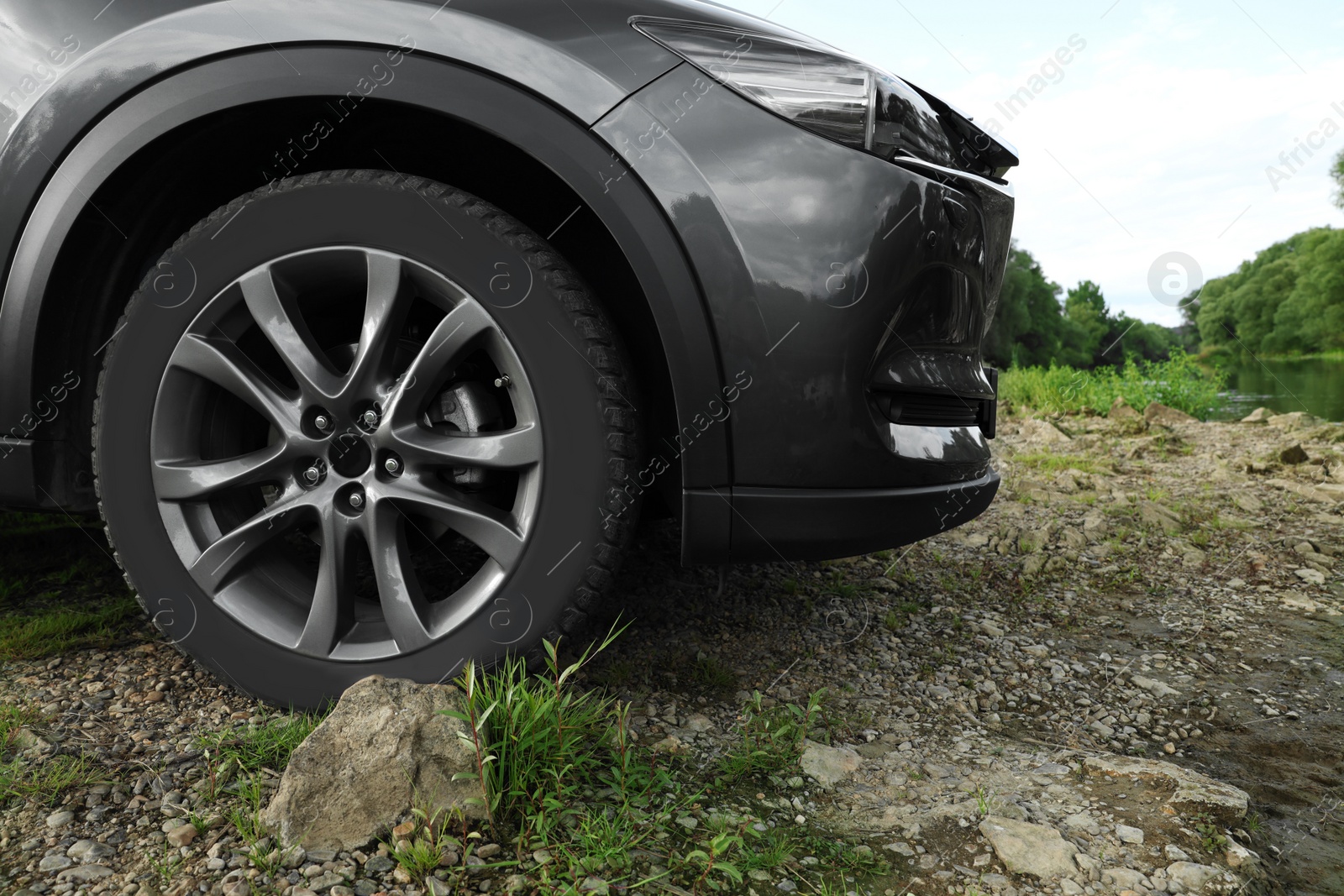 Photo of New black modern car near river , closeup