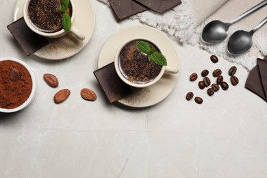 Photo of Delicious hot chocolate with fresh mint served on grey table, flat lay. Space for text