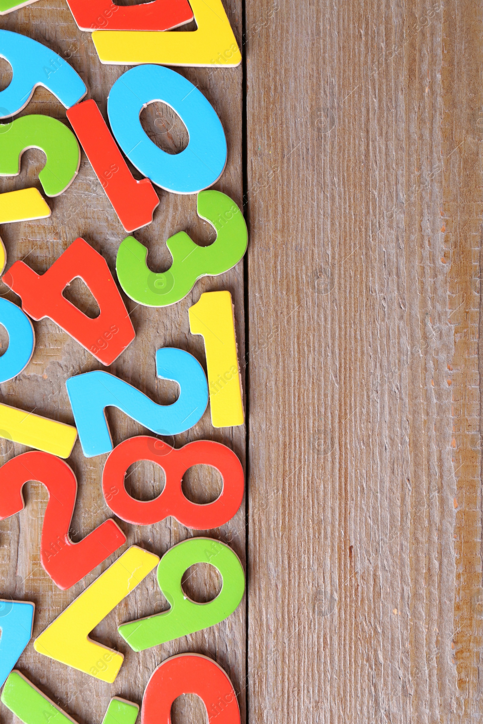 Photo of Colorful numbers on wooden table, flat lay. Space for text