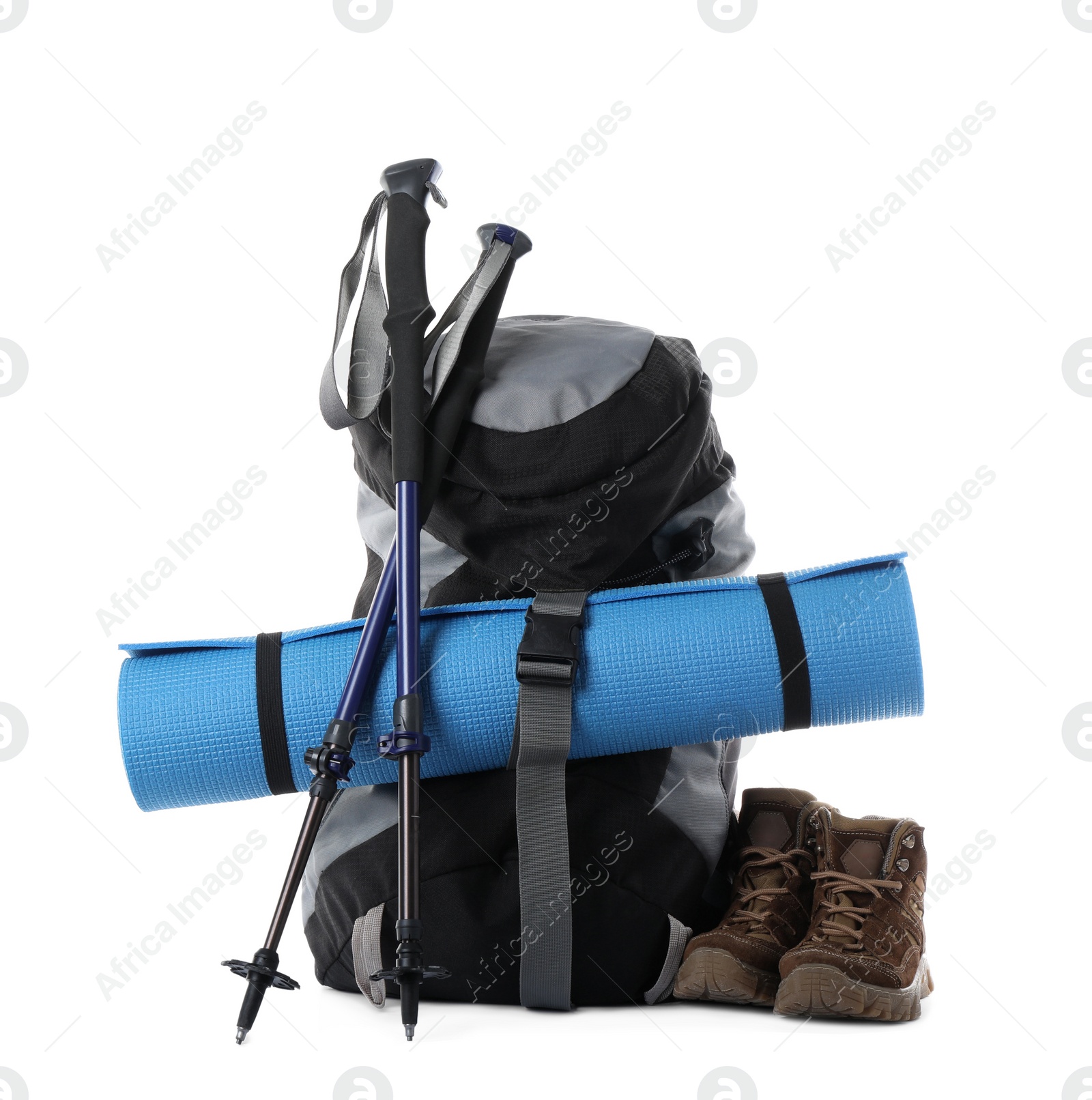 Photo of Pair of trekking poles and camping equipment for tourism on white background