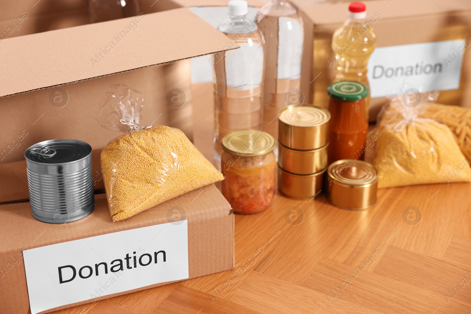 Photo of Volunteering. Different food products and cardboard boxes on table