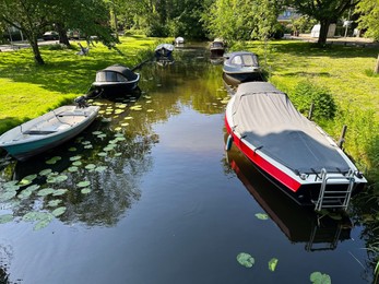 Beautiful view of canal with moored boats outdoors on sunny day