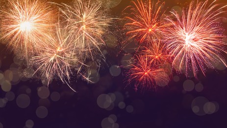 Image of Beautiful bright fireworks lighting up night sky. Bokeh effect