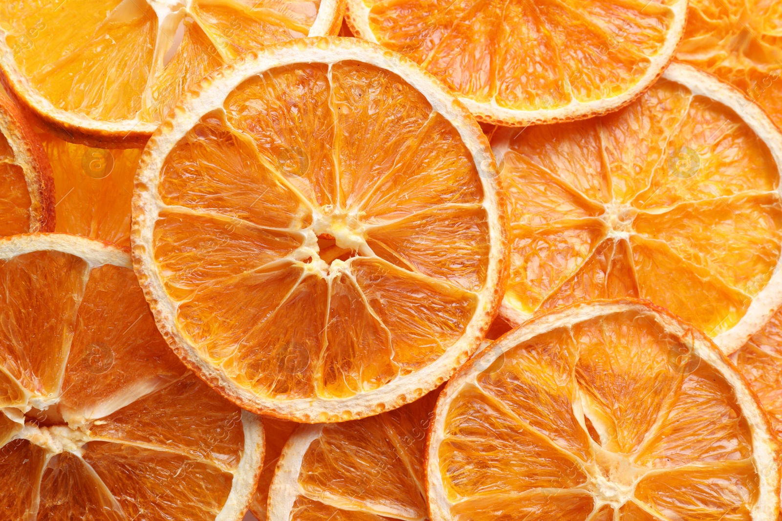 Delicious dry orange slices as background, top view Photo of Delicious dry orange slices as background, top view