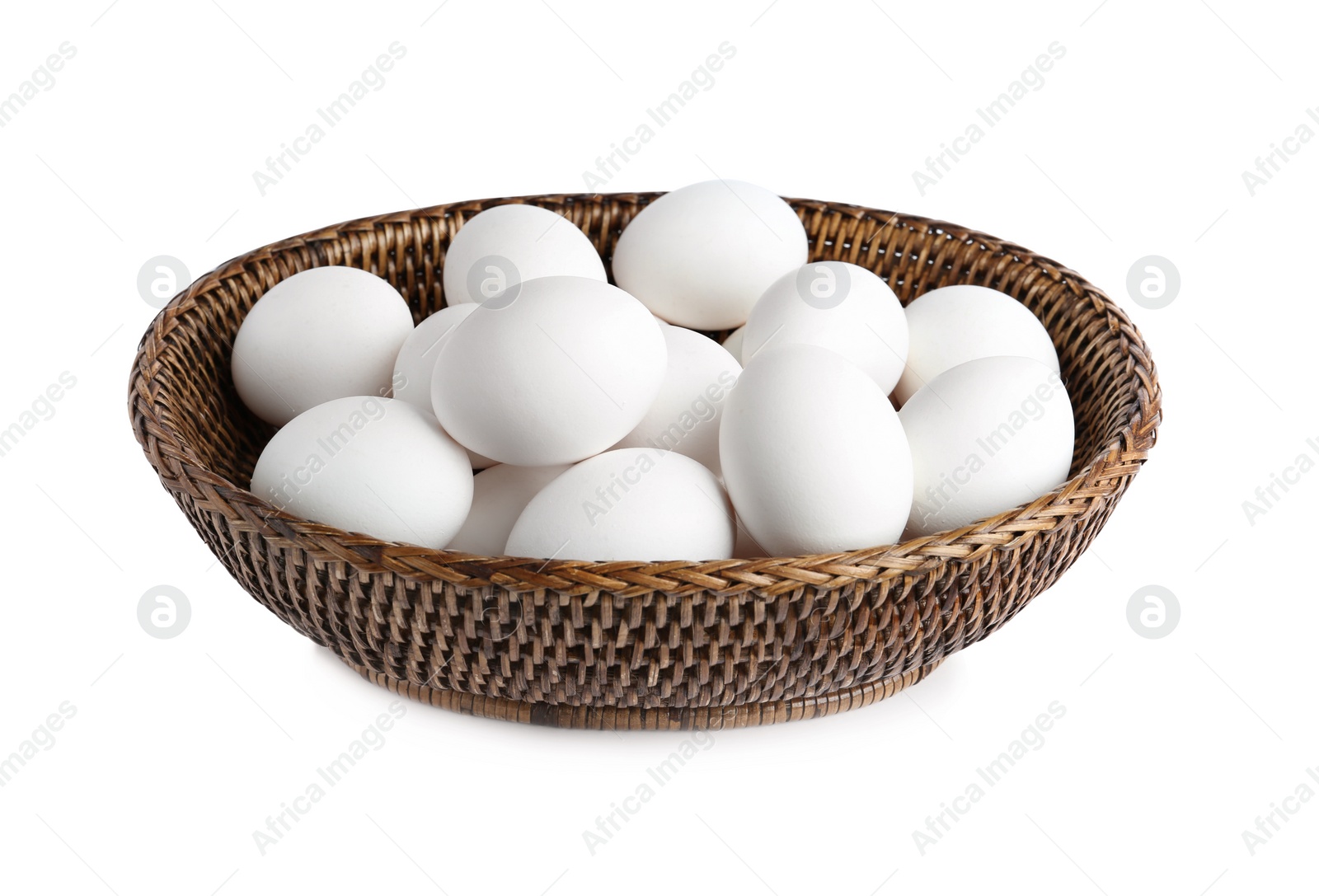 Photo of Chicken eggs in wicker bowl isolated on white