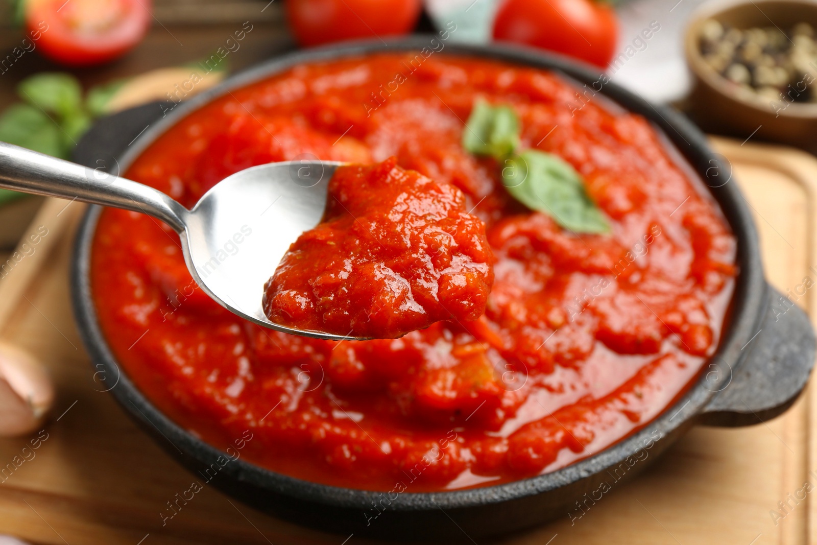 Photo of Eating homemade tomato sauce at table, closeup