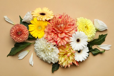 Photo of Flat lay composition with beautiful dahlia flowers on beige background