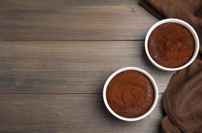 Photo of Delicious fresh chocolate fondant on wooden table, flat lay. Space for text