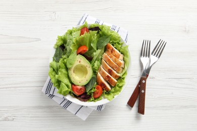 Photo of Delicious salad with chicken, cherry tomato and avocado served on white wooden table, top view