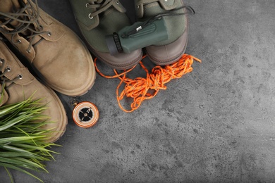 Flat lay composition with camping equipment on grey background