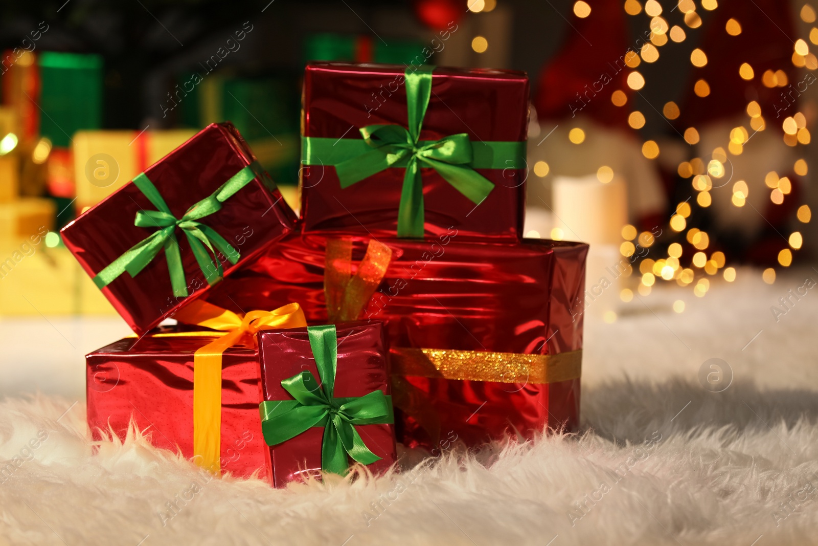 Photo of Beautiful Christmas gifts on furry carpet in room