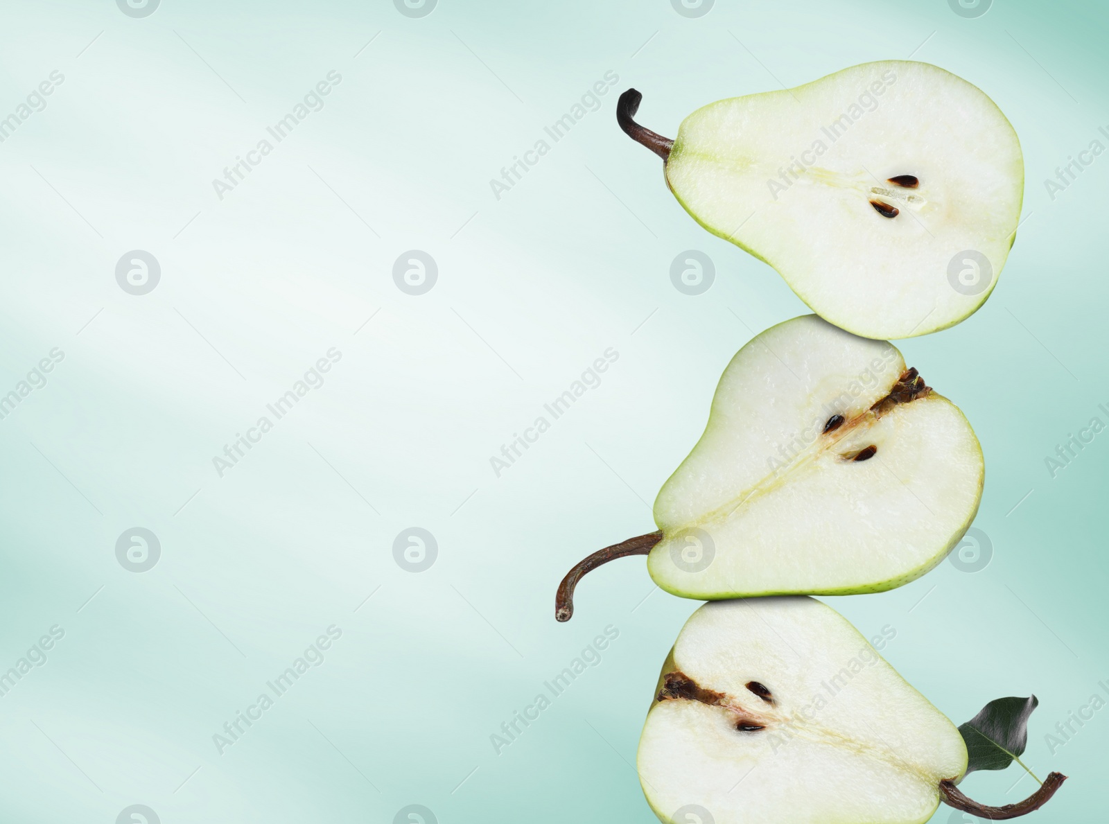 Image of Cut fresh ripe pears on turquoise gradient background, space for text