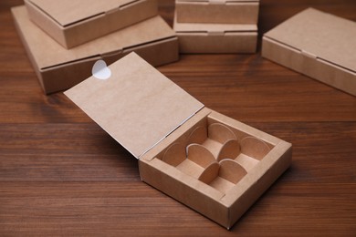 Photo of Empty packaging box with dividers on wooden table. Production line