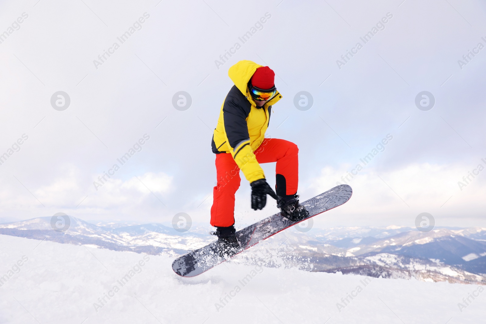 Photo of Male snowboarder on snowy hill. Winter vacation