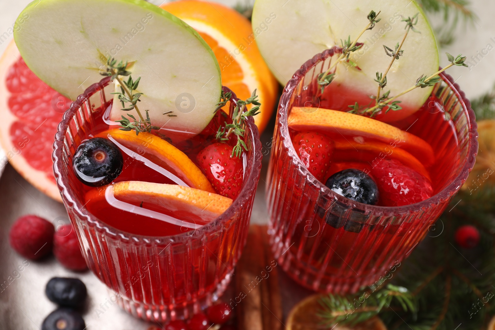 Photo of Aromatic Christmas Sangria in glasses served on table, above view