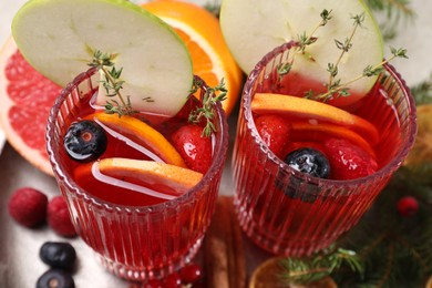 Aromatic Christmas Sangria in glasses served on table, above view