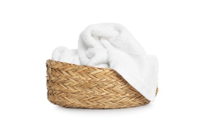 Photo of Wicker basket with crumpled bath towel isolated on white