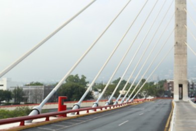 Photo of Blurred view of modern bridge near city