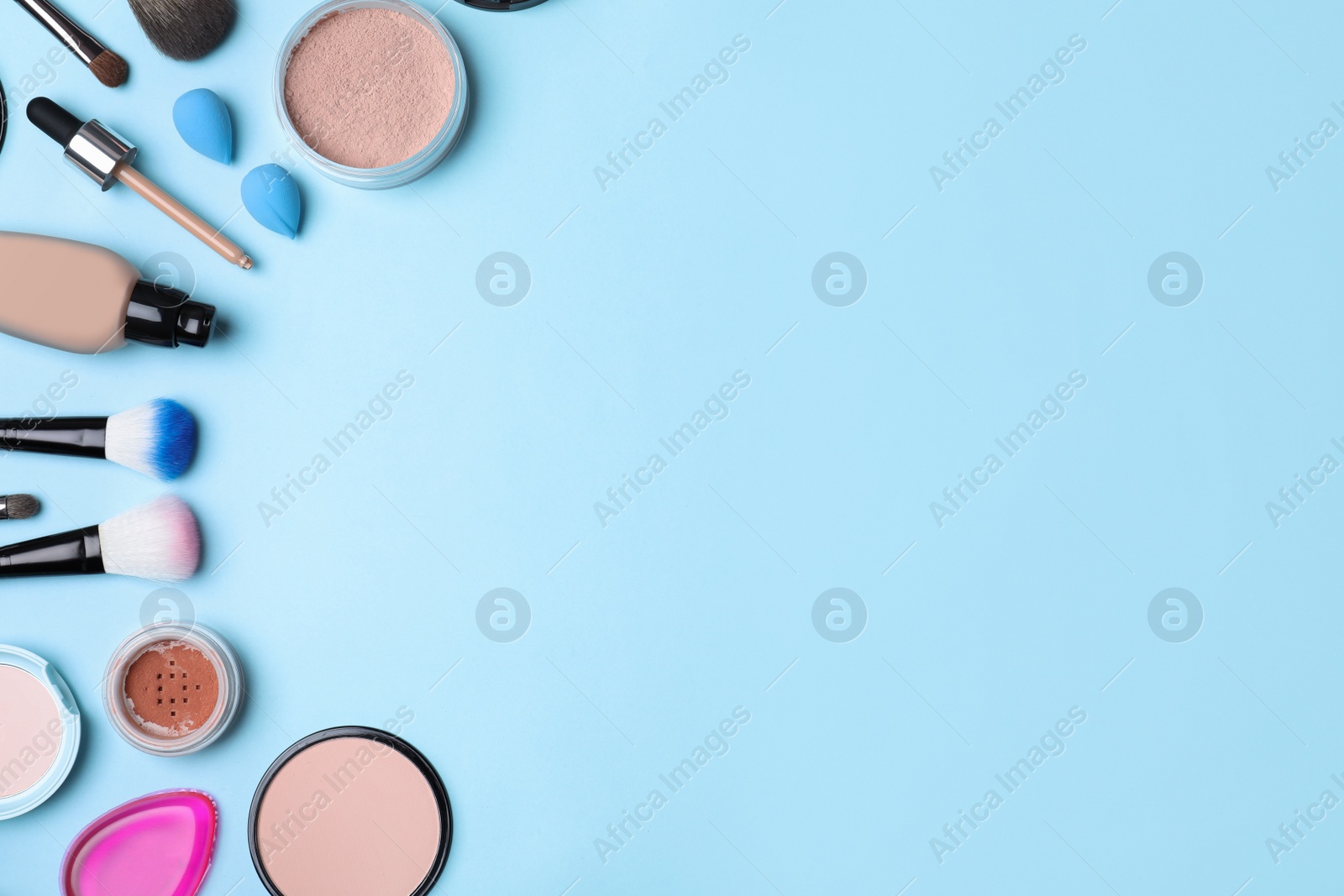 Photo of Flat lay composition with skin foundation, powder and beauty accessories on color background. Space for text