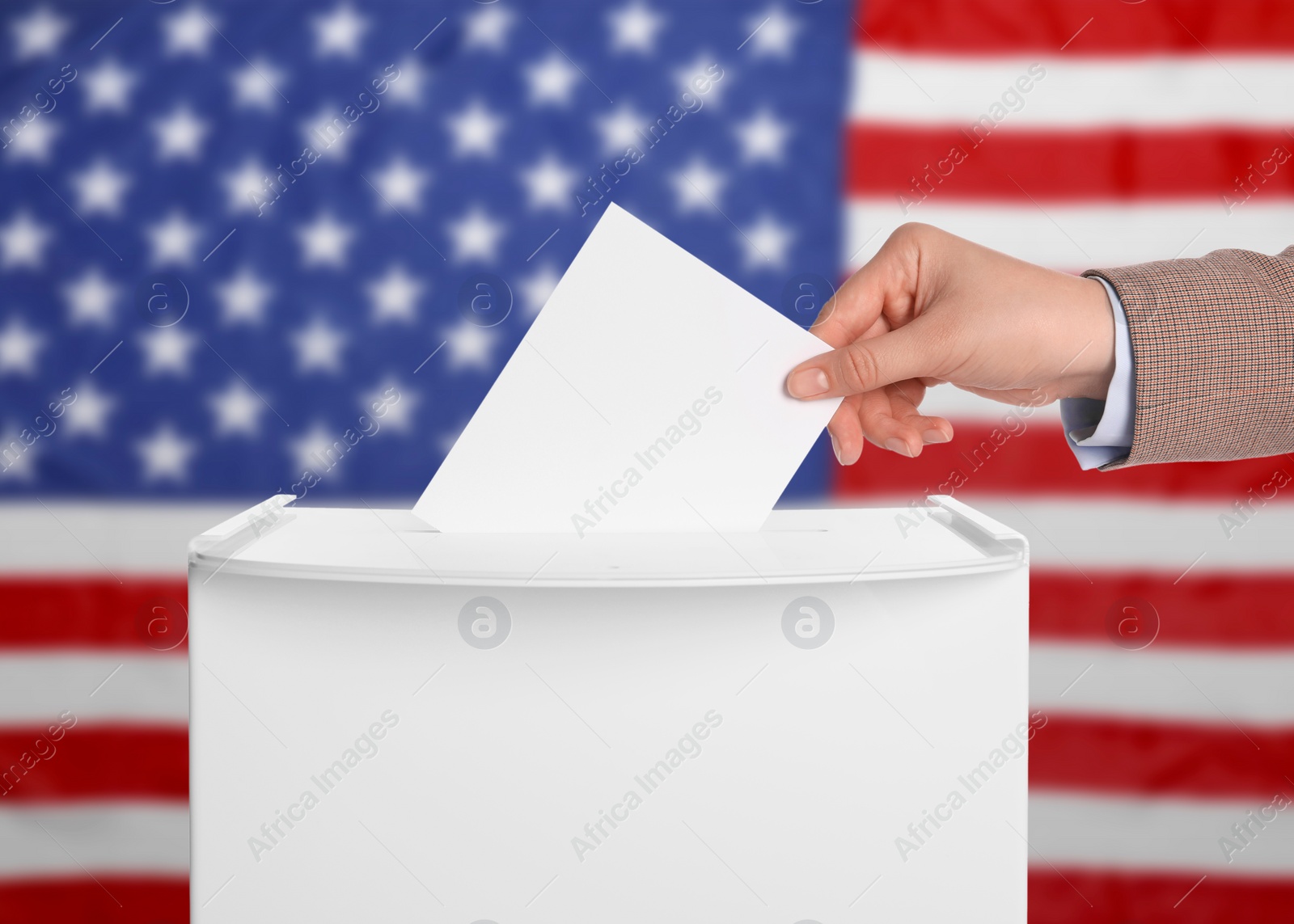 Image of Election in USA. Woman putting her vote into ballot box against national flag of United States, closeup