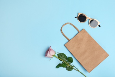 Stylish flat lay composition with shopping bag on color background