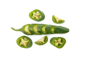 Whole and cut green hot chili peppers on white background, flat lay