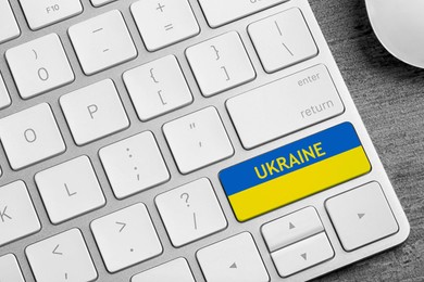 Image of Button in colors of Ukrainian flag on keyboard, top view