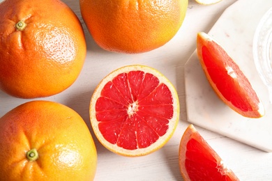 Flat lay composition with grapefruits on wooden background