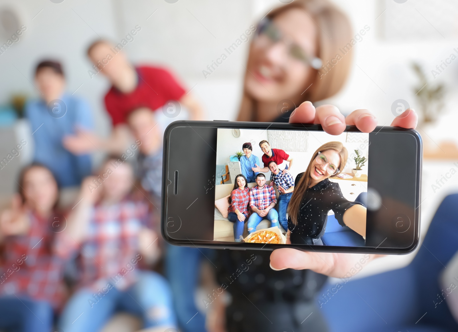 Photo of Happy friends taking selfie indoors