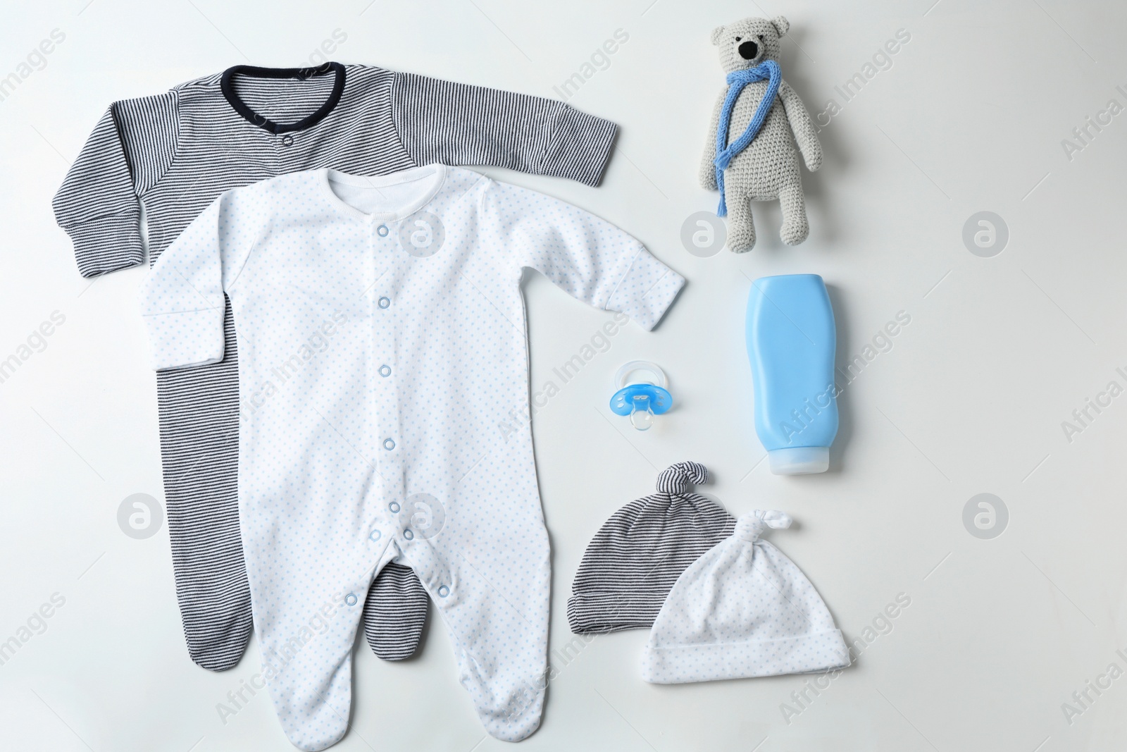 Photo of Flat lay composition with baby clothes and accessories on white background