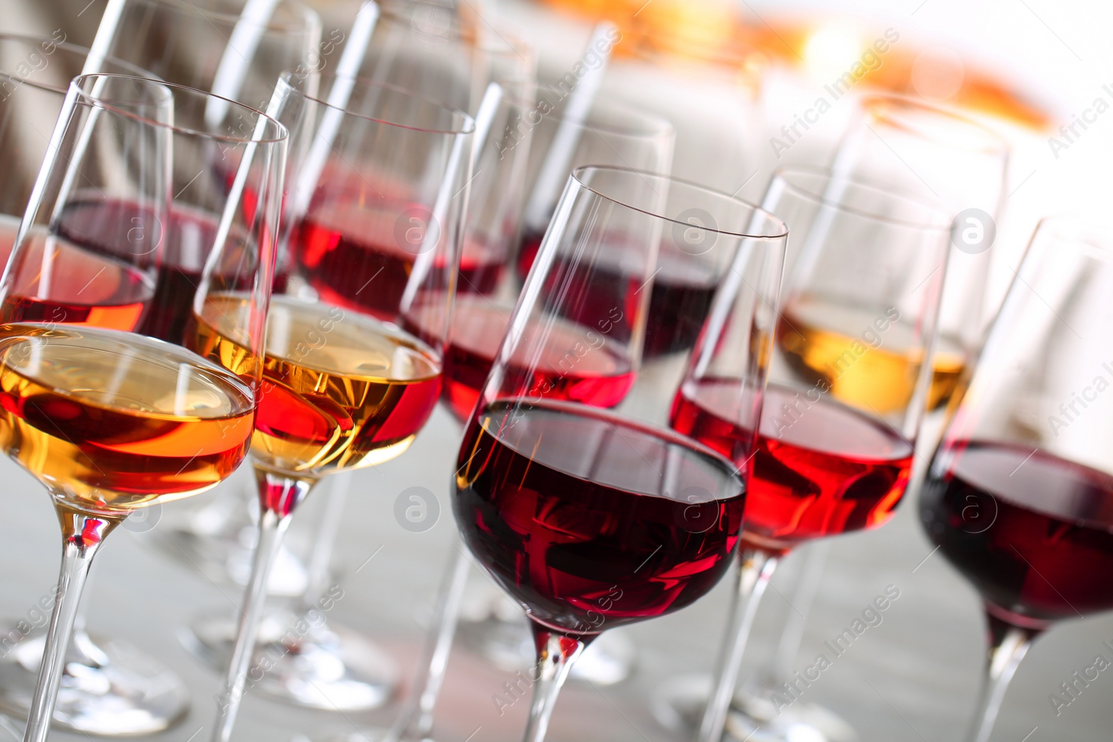 Photo of Glasses with different wines on blurred background, closeup