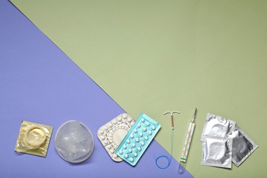 Contraceptive pills, condoms, intrauterine device and thermometer on color background, flat lay and space for text. Different birth control methods
