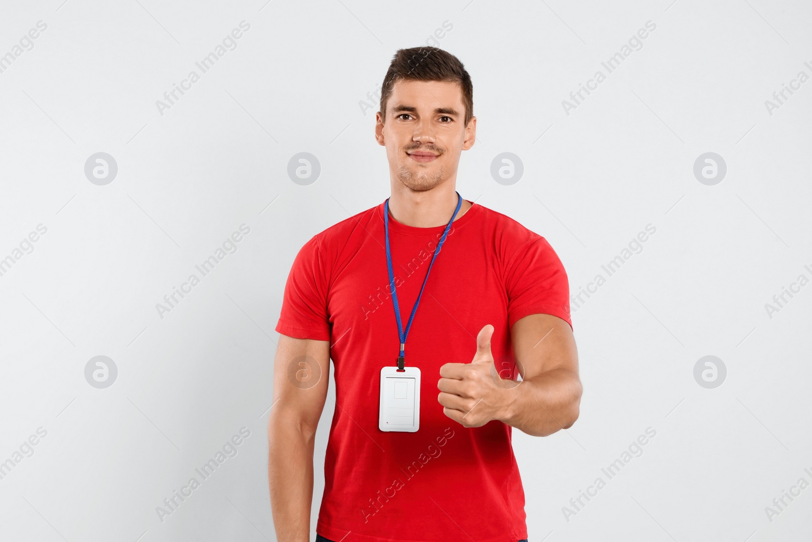 Photo of Portrait of happy young courier on white background