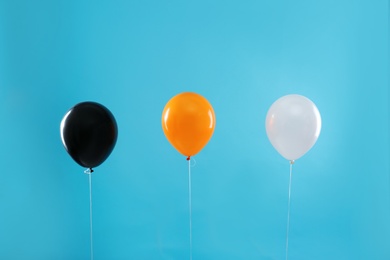 Photo of Colorful balloons on blue background. Halloween party