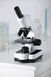 Modern medical microscope on white table in laboratory