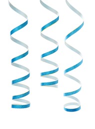 Photo of Light blue serpentine streamers on white background. Festive decor