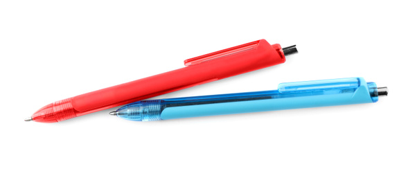 Photo of Red and blue retractable pens isolated on white, top view