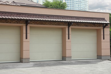 Photo of Building with white sectional garage doors on sunny day