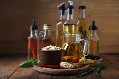 Photo of Different cooking oils and ingredients on wooden table