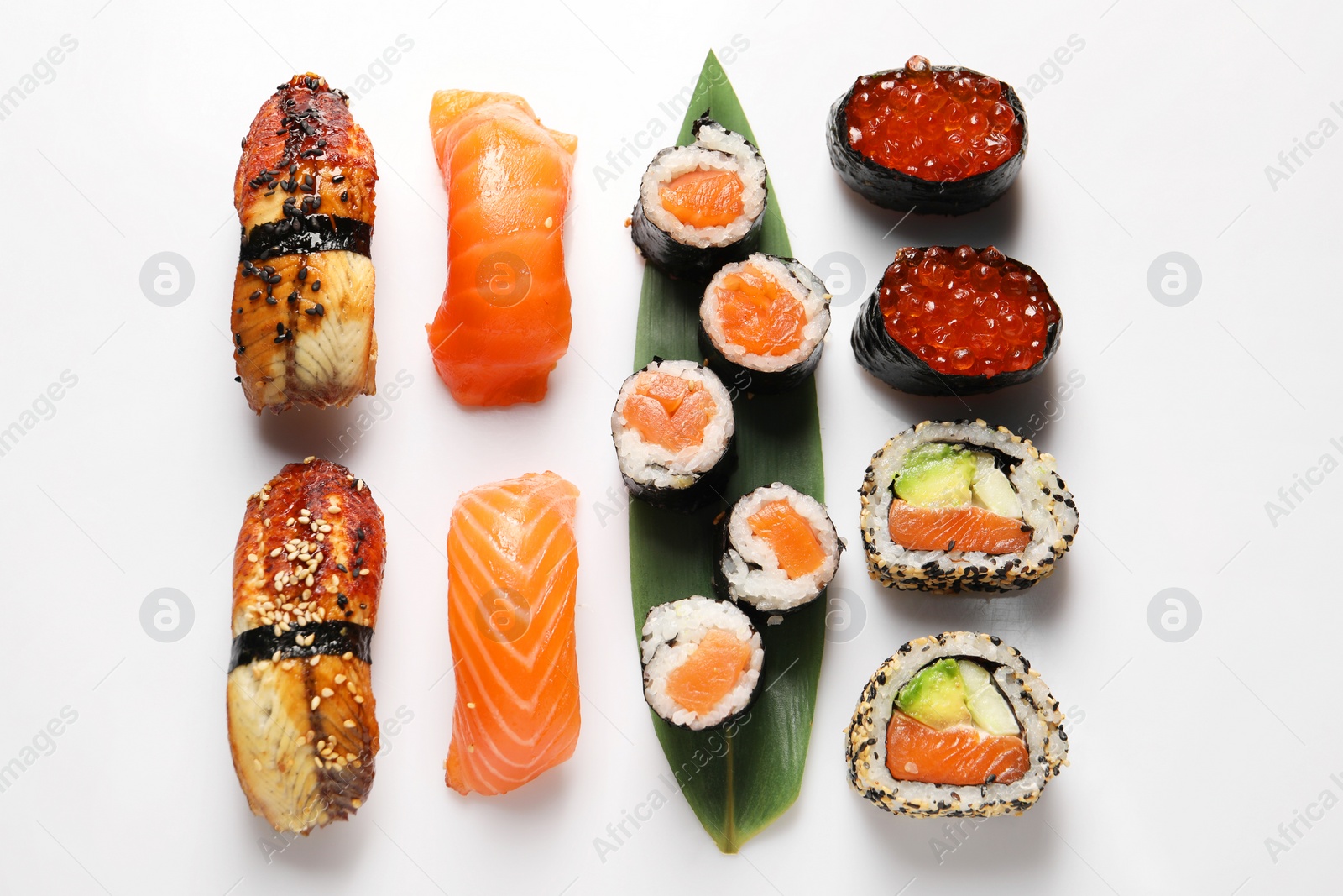 Photo of Different tasty sushi rolls on white background, flat lay