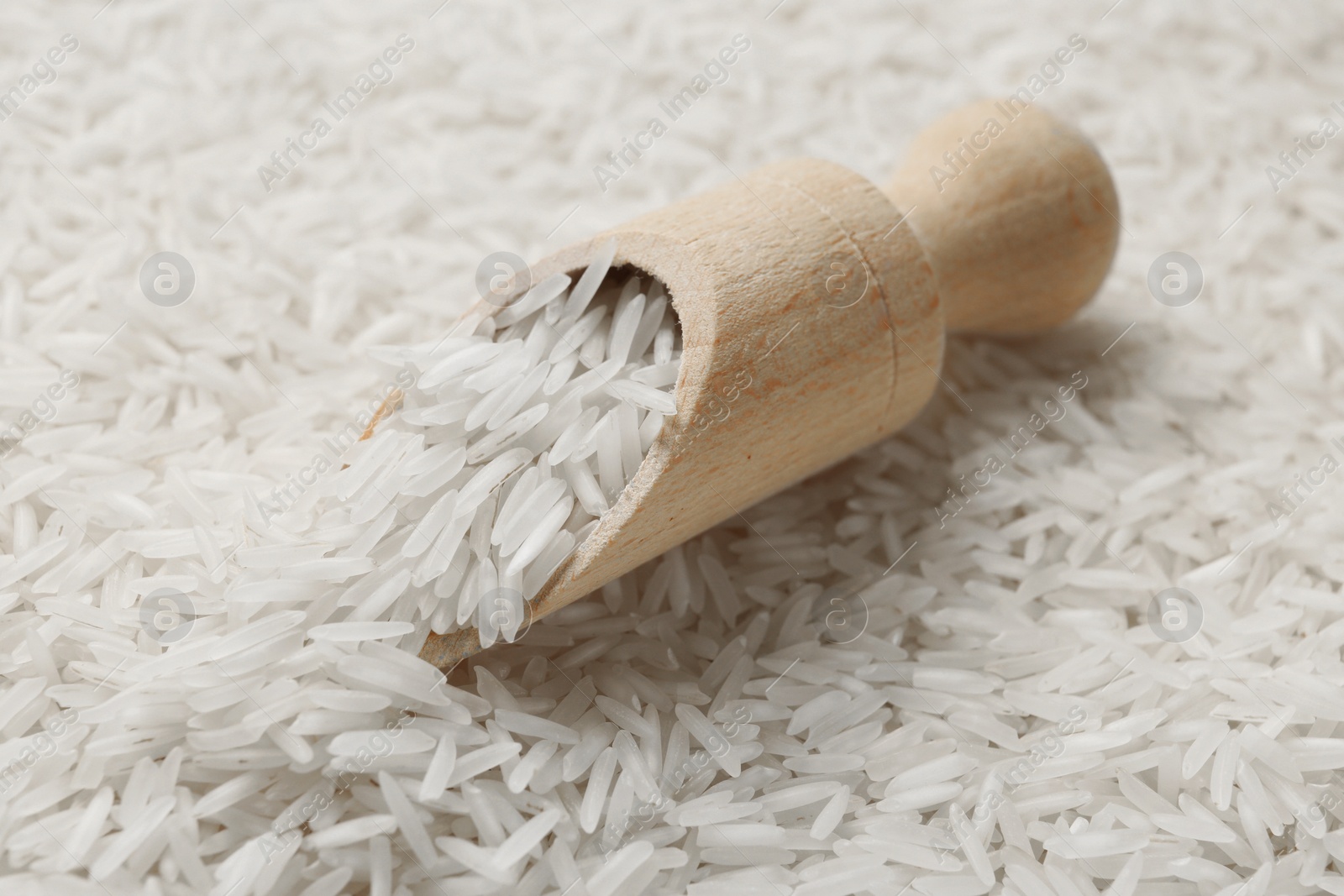 Photo of Raw basmati rice and scoop, closeup view