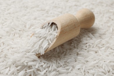 Raw basmati rice and scoop, closeup view