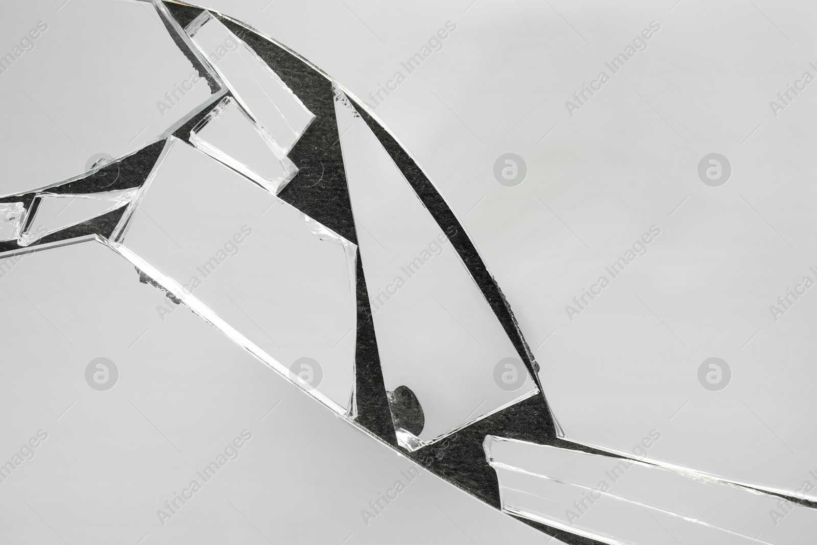 Photo of Shards of broken mirror on dark background, top view