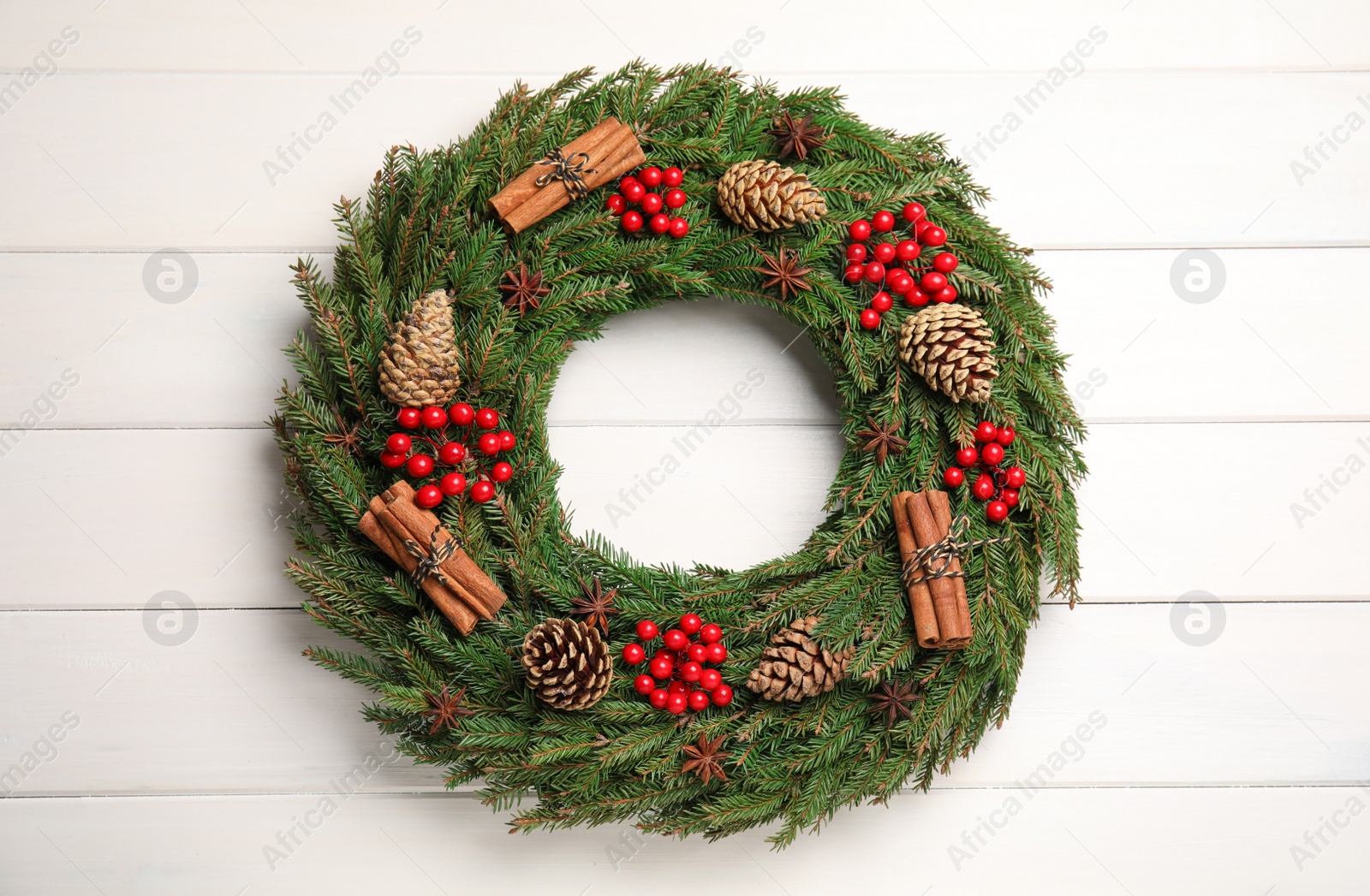 Photo of Beautiful Christmas wreath on white wooden background, top view