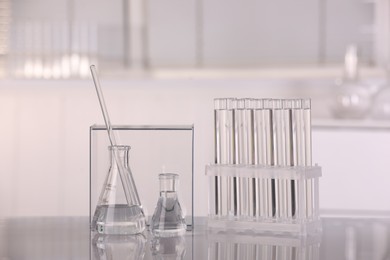 Photo of Laboratory analysis. Different glassware with liquid on white table indoors