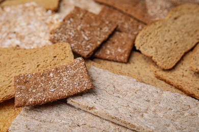 Photo of Fresh rye crispbreads and rusks as background, closeup