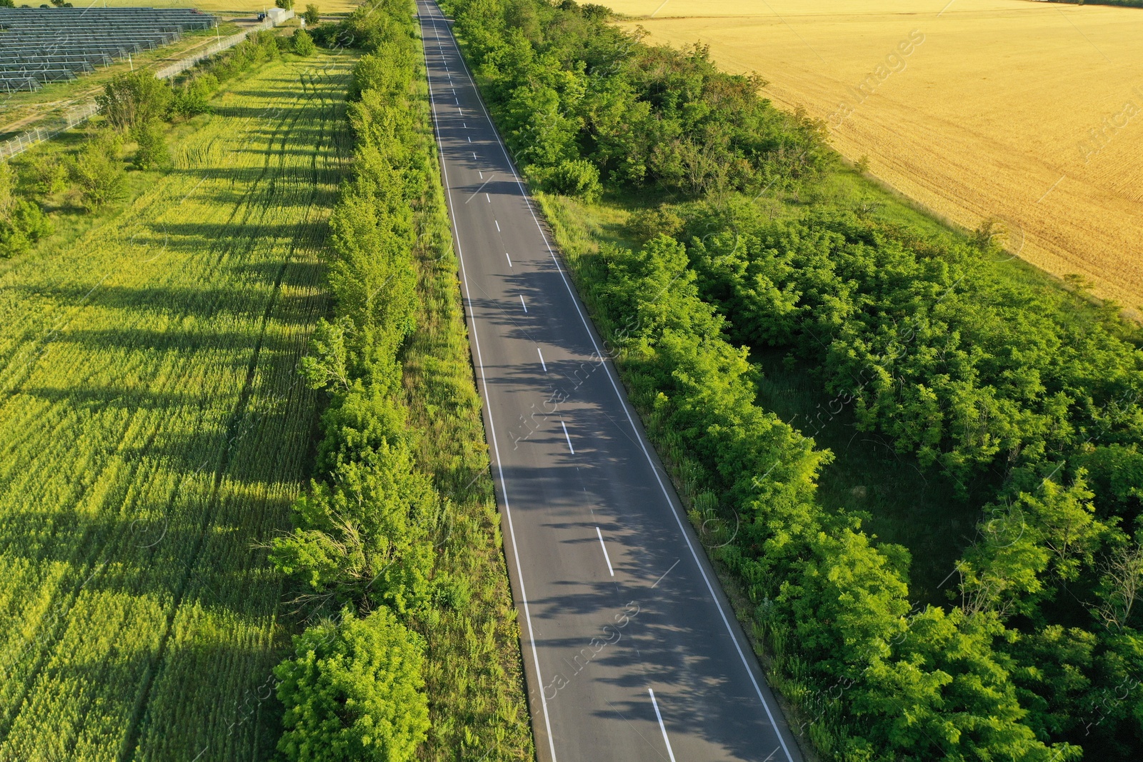 Photo of Beautiful view of empty road and solar panels on sunny day