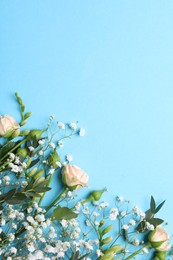 Photo of Beautiful floral composition with gypsophila and roses on light blue background, flat lay. Space for text