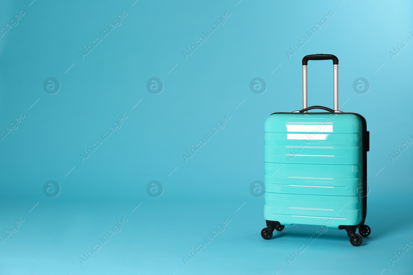 Photo of Stylish suitcase on color background. Space for text