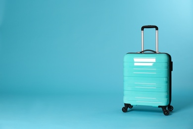 Stylish suitcase on color background. Space for text